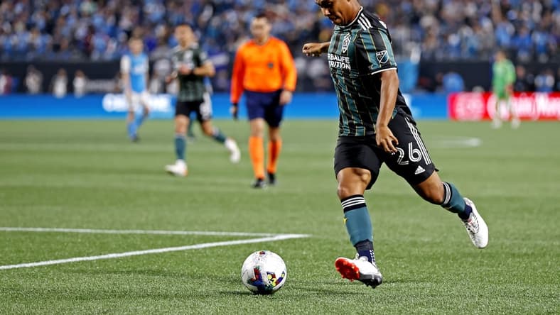 Mar 5, 2022; Charlotte, North Carolina, USA; Los Angeles Galaxy midfielder Efrain Alvarez (26) shoots the ball against Charlotte FC at Bank of America Stadium. Mandatory Credit: Nell Redmond-USA TODAY Sports