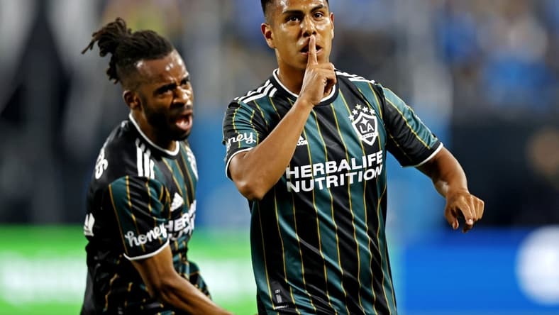 Mar 5, 2022; Charlotte, North Carolina, USA; Los Angeles Galaxy midfielder Efrain Alvarez (26) celebrates scoring a goal against the Los Angeles Galaxy during the second half at Bank of America Stadium. Mandatory Credit: Nell Redmond-USA TODAY Sports