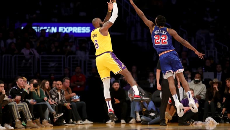 Mar 5, 2022; Los Angeles, California, USA; Los Angeles Lakers forward LeBron James (6) shoots a ball over Golden State Warriors forward Andrew Wiggins (22) during the first quarter at Crypto.com Arena. Mandatory Credit: Kiyoshi Mio-USA TODAY Sports