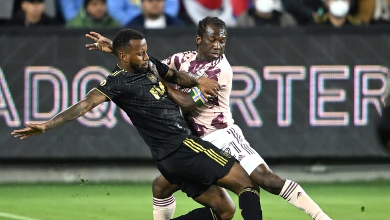 Mar 6, 2022; Los Angeles, California, USA; Portland Timbers midfielder Diego Chara (21) and Los Angeles FC defender Jesus Murillo (3) go for the ball in the first half at Banc of California Stadium. Mandatory Credit: Jayne Kamin-Oncea-USA TODAY Sports