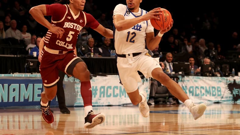 Mar 8, 2022; Brooklyn, NY, USA; Pittsburgh Panthers guard Ithiel Horton (12) drives to the basket against Boston College Eagles guard DeMarr Langford Jr. (5) during the first half at Barclays Center. Mandatory Credit: Brad Penner-USA TODAY Sports