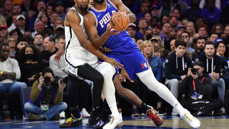 Mar 10, 2022; Philadelphia, Pennsylvania, USA; Philadelphia 76ers center Joel Embiid (21) is fouled by Brooklyn Nets forward Kevin Durant (7) during the first quarter at Wells Fargo Center. Mandatory Credit: Eric Hartline-USA TODAY Sports