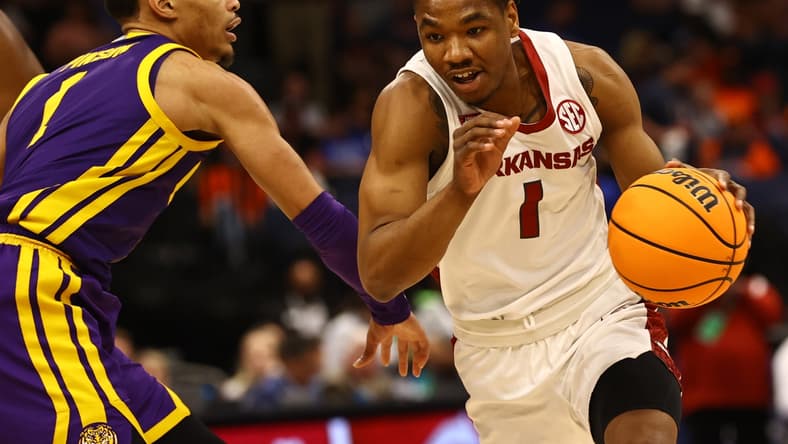 Mar 11, 2022; Tampa, FL, USA; Arkansas Razorbacks drives to the basket as LSU Tigers guard Xavier Pinson (1) defends during the first half at Amalie Arena. Mandatory Credit: Kim Klement-USA TODAY Sports