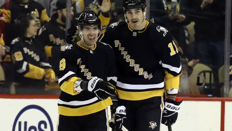Mar 11, 2022; Pittsburgh, Pennsylvania, USA; Pittsburgh Penguins center Evan Rodrigues (9) celebrates his goal with center Brian Boyle (11) against the Vegas Golden Knights during the third period at PPG Paints Arena. The Penguins won 5-2. Mandatory Credit: Charles LeClaire-USA TODAY Sports