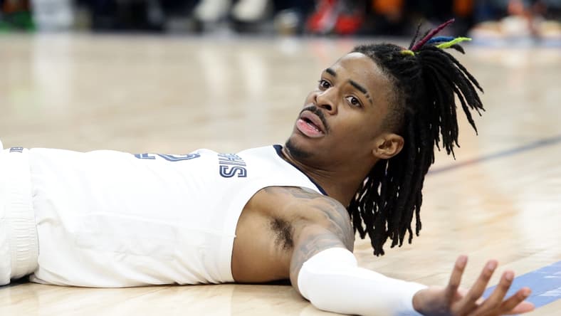Mar 11, 2022; Memphis, Tennessee, USA; Memphis Grizzlies guard Ja Morant (12) lays on the floor after a foul during the second half against the New York Knicks at FedExForum. Mandatory Credit: Petre Thomas-USA TODAY Sports