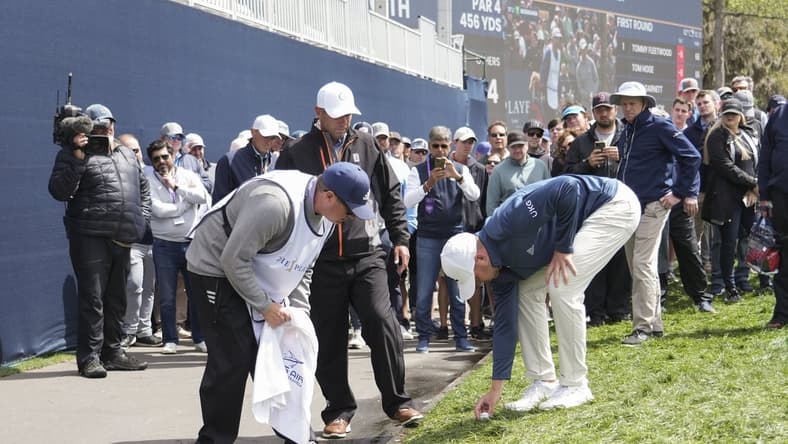 Mar 12, 2022; Ponte Vedra Beach, Florida, USA; Daniel Berger sets his ball after getting relief on the 18th hole during the first round of THE PLAYERS Championship golf tournament. Mandatory Credit: David Yeazell-USA TODAY Sports