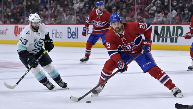 Mar 12, 2022; Montreal, Quebec, CAN; Montreal Canadiens defenseman Jeff Petry (26) takes a shot and Seattle Kraken forward Colin Blackwell (43) defends during the first period at the Bell Centre. Mandatory Credit: Eric Bolte-USA TODAY Sports