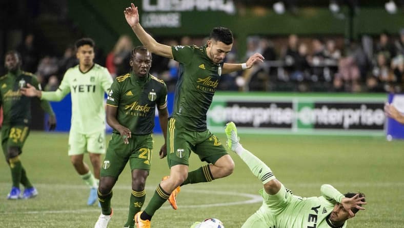 Mar 12, 2022; Portland, Oregon, USA; Austin FC forward Maximiliano Urruti (37) falls down during the first half against Portland Timbers midfielder Cristhian Paredes (22) at Providence Park. Mandatory Credit: Troy Wayrynen-USA TODAY Sports
