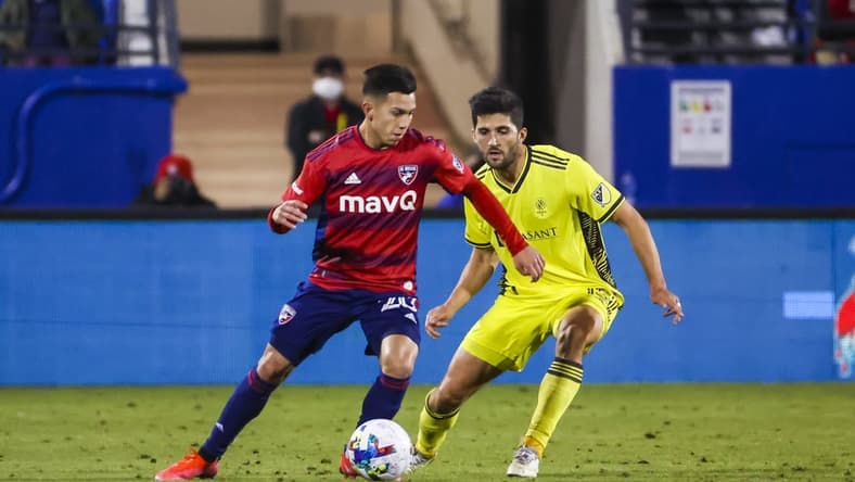 Mar 12, 2022; Frisco, Texas, USA;  FC Dallas forward Alan Velasco (20) controls the ball in front of Nashville SC defender Eric Miller (15) during the second half at Toyota Stadium. Mandatory Credit: Kevin Jairaj-USA TODAY Sports
