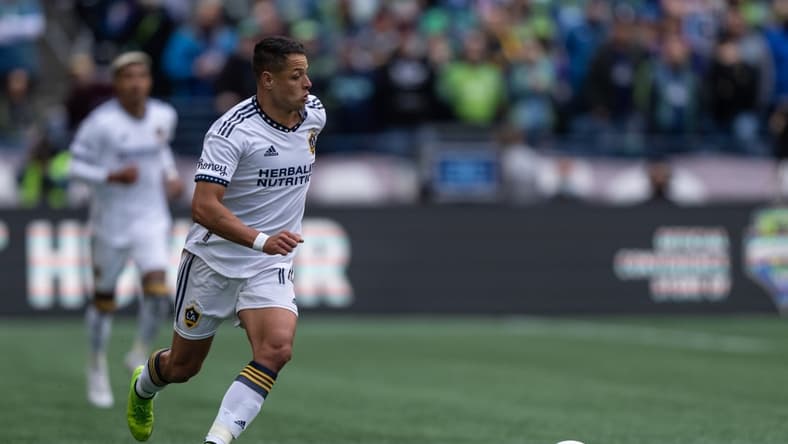 Mar 12, 2022; Seattle, Washington, USA; LA Galaxy forward Chicharito (14) dribbles the ball against Seattle Sounders FC at Lumen Field. Mandatory Credit: Stephen Brashear-USA TODAY Sports