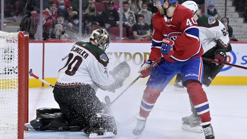 Mar 15, 2022; Montreal, Quebec, CAN; Arizona Coyotes goalie Karel Vejmelka (70) makes a save against Montreal Canadiens forward Joel Armia (40) during the second period at the Bell Centre. Mandatory Credit: Eric Bolte-USA TODAY Sports