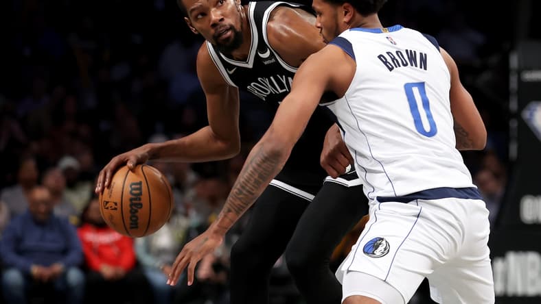 Mar 16, 2022; Brooklyn, New York, USA; Brooklyn Nets forward Kevin Durant (7) controls the ball against Dallas Mavericks forward Sterling Brown (0) during the third quarter at Barclays Center. Mandatory Credit: Brad Penner-USA TODAY Sports