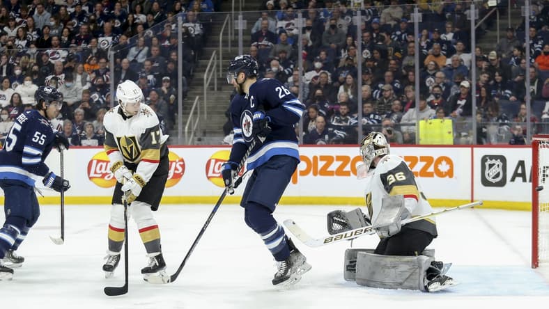 Mar 22, 2022; Winnipeg, Manitoba, CAN;  Winnipeg Jets forward Mark Scheifele (55) scores against Vegas Golden Knights goalie Logan Thompson (36) during the second period at Canada Life Centre. Mandatory Credit: Terrence Lee-USA TODAY Sports