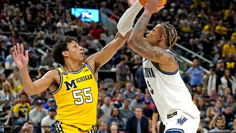 Mar 24, 2022; San Antonio, TX, USA; Villanova Wildcats guard Justin Moore (5) drives to the basket against Michigan Wolverines guard Eli Brooks (55) in the semifinals of the South regional of the men's college basketball NCAA Tournament at AT&T Center. Mandatory Credit: Scott Wachter-USA TODAY Sports