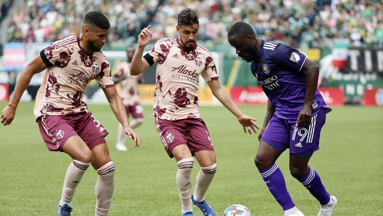 Mar 27, 2022; Portland, Oregon, USA;  Orlando City SC forward Benji Michel (19) controls the ball against Portland Timbers defender Jose Van Rankin (2) during the first half at Providence Park. Mandatory Credit: Soobum Im-USA TODAY Sports