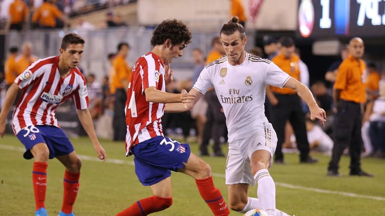 Jul 26, 2019; East Rutherford, NJ, USA; Real Madrid forward Gareth Bale (11) dribbles the ball as Atletico de Madrid forward Sergio Camello (34) defends during the second half of an International Champions Cup soccer series match at MetLife Stadium. Mandatory Credit: Brad Penner-USA TODAY Sports