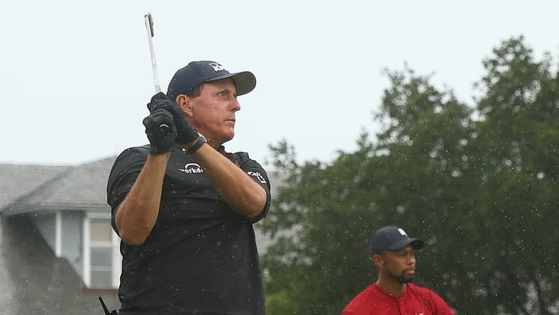 May 24, 2020; Hobe Sound, FL, USA; Phil Mickelson plays his shot from the first tee as Tiger Woods looks on during The Match: Champions for Charity golf round at the Medalist Golf Club. Mandatory Credit: Handout Photo by Getty Images for The Match via USA TODAY Sports