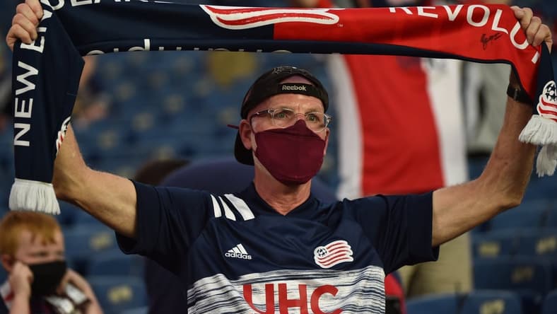 May 22, 2021; Foxborough, Massachusetts, USA;  A New England Revolution fan holds a banner as the New England Revolution and New York Red Bulls enter the field at Gillette Stadium. Mandatory Credit: Bob DeChiara-USA TODAY Sports