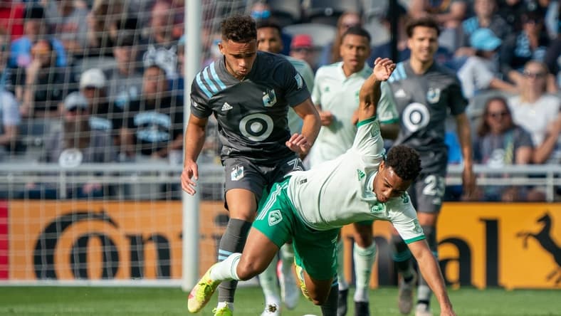 Oct 10, 2021; Saint Paul, Minnesota, USA; Colorado Rapids defender Auston Trusty (5) is tripped by Minnesota United midfielder Hassani Dotson (31) in the first half at Allianz Field. Mandatory Credit: Matt Blewett-USA TODAY Sports