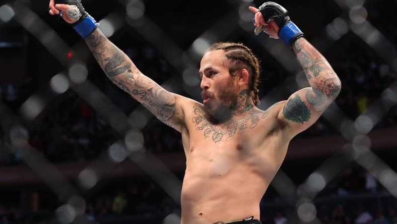 Nov 6, 2021; New York, NY, USA; Marlon Vera (blue gloves) celebrates after defeating Frankie Edgar (red gloves) during UFC 268 at Madison Square Garden. Mandatory Credit: Ed Mulholland-USA TODAY Sports