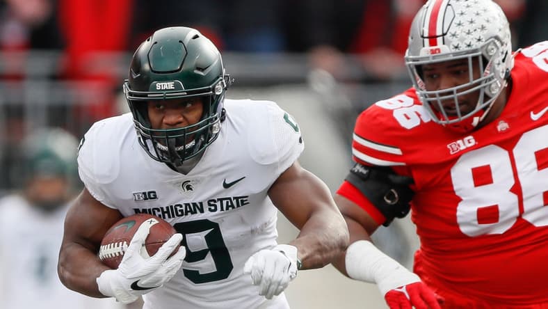 Michigan State Spartans running back Kenneth Walker III (9) runs past Ohio State Buckeyes defensive tackle Jerron Cage (86) during the first quarter of the NCAA football game at Ohio Stadium in Columbus on Saturday, Nov. 20, 2021.
Michigan State Spartans At Ohio State Buckeyes Football