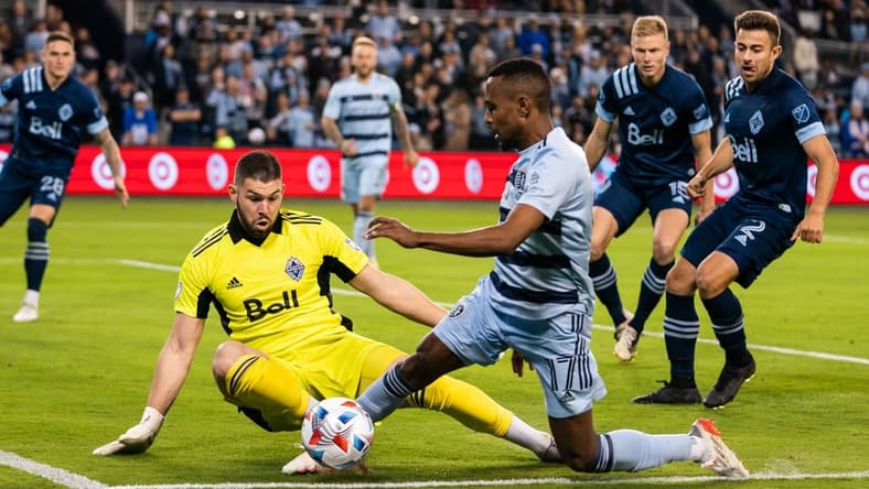 Nov 20, 2021; Kansas City, KS, USA; Sporting Kansas City midfielder Gadi Kinda (17) and Vancouver Whitecaps goalkeeper Maxime Crepeau (16) during the second half at Children's Mercy Park. Mandatory Credit: Jay Biggerstaff-USA TODAY Sports