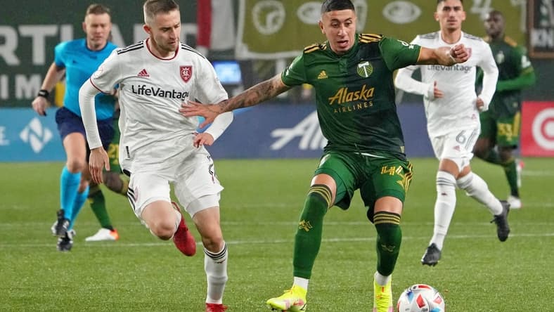 Dec 4, 2021; Portland, Oregon, USA; Portland Timbers midfielder Marvin Loria (44) dribbles the ball as Real Salt Lake defender Andrew Brody (2) gives chase during the second half during the Western Conference Finals of the 2021 MLS Playoffs at Providence Park. Mandatory Credit: Kirby Lee-USA TODAY Sports