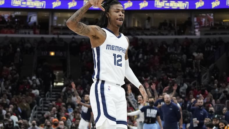 Feb 26, 2022; Chicago, Illinois, USA; Memphis Grizzlies guard Ja Morant (12) celebrates a three point basket against the Chicago Bulls during the first half at United Center. Mandatory Credit: David Banks-USA TODAY Sports
