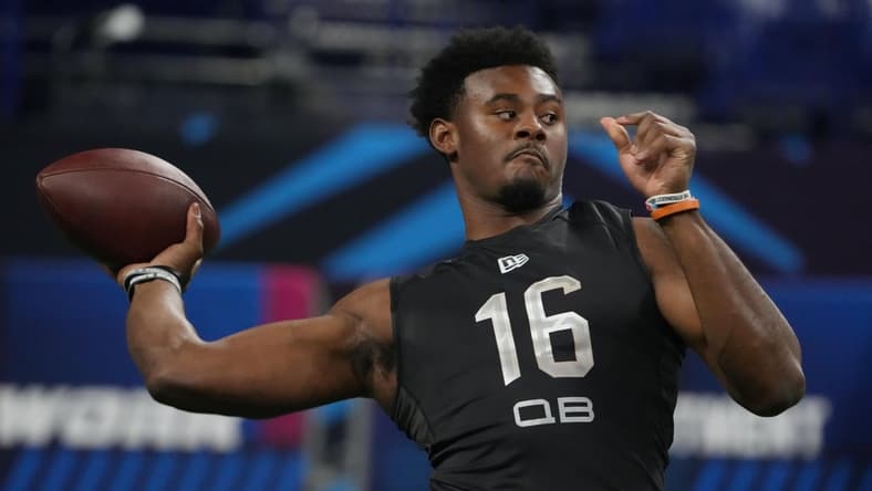 Mar 3, 2022; Indianapolis, IN, USA; Liberty quarterback Malik Willis (QB16) goes through a drill during the 2022 NFL Scouting Combine at Lucas Oil Stadium. Mandatory Credit: Kirby Lee-USA TODAY Sports
