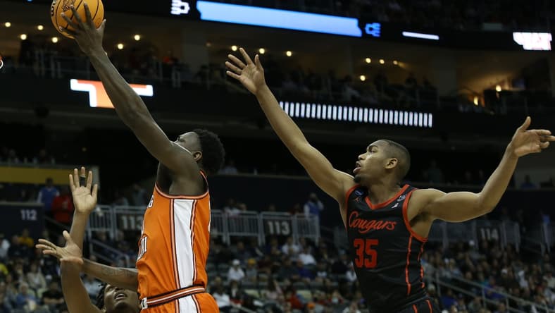 Mar 20, 2022; Pittsburgh, PA, USA; Illinois Fighting Illini center Kofi Cockburn (21) shoots the ball against Houston Cougars forward Fabian White Jr. (35) in the second half during the second round of the 2022 NCAA Tournament at PPG Paints Arena. Mandatory Credit: Charles LeClaire-USA TODAY Sports