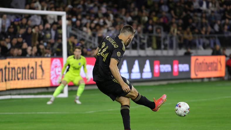Mar 20, 2022; Los Angeles, California, USA; Los Angeles FC midfielder Ryan Hollingshead (24) passes the ball during the first half against the Vancouver Whitecaps FC at Banc of California Stadium. LAFC won 3-1. Mandatory Credit: Kiyoshi Mio-USA TODAY Sports