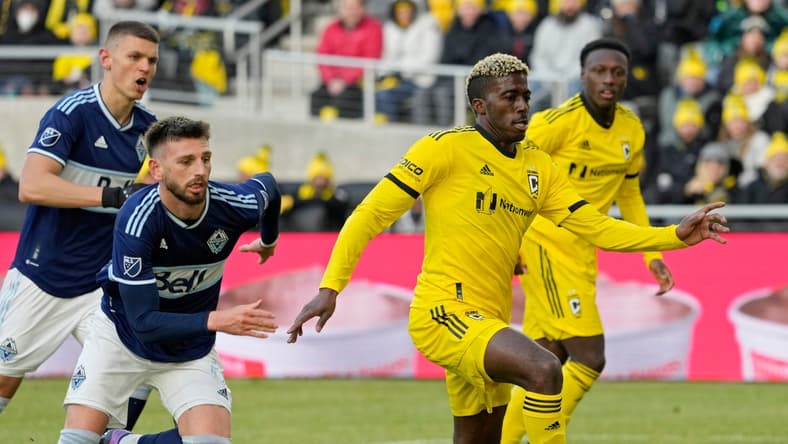 Columbus Crew forward Gyasi Zardes (11) is pursued by Vancouver Whitecaps defender Tristan Blackmon (6) during the second half of Saturday's season opener at Lower.com field in Columbus, Oh., on February 26, 2022.

Ceb Crew 0227 Bjp 39