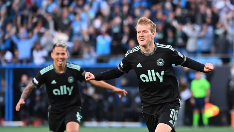 Mar 26, 2022; Charlotte, North Carolina, USA;  Charlotte FC forward Karol Swiderski (11) celebrates with midfielder Jordy Alcivar (8) after scoring a goal in the second half at Bank of America Stadium. Mandatory Credit: Bob Donnan-USA TODAY Sports