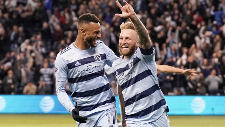 Mar 26, 2022; Kansas City, Kansas, USA; Sporting Kansas City forward Johnny Russell (7) celebrates with forward Khiry Shelton (11) after scoring against Real Salt Lake during the second half at Children's Mercy Park. Mandatory Credit: Denny Medley-USA TODAY Sports