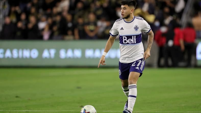 Mar 20, 2022; Los Angeles, California, USA; Vancouver Whitecaps FC midfielder Ryan Raposo (27) dribbles the ball during the second half against the Los Angeles FC at Banc of California Stadium. LAFC won 3-1. Mandatory Credit: Kiyoshi Mio-USA TODAY Sports