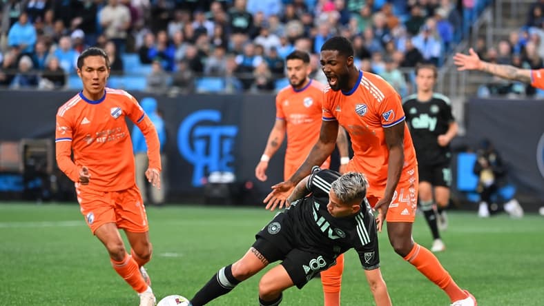 Mar 26, 2022; Charlotte, North Carolina, USA; Charlotte FC midfielder Jordy Alcivar (8) with the ball as FC Cincinnati forward Yuya Kubo (7) and defender Tyler Blackett (24) defend in the second half at Bank of America Stadium. Mandatory Credit: Bob Donnan-USA TODAY Sports