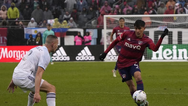 Apr 2, 2022; Chicago, Illinois, USA; FC Dallas defender Marco Farfan (4) makes a pass on Chicago Fire defender Boris Sekulic (2) during the first half at Soldier Field. Mandatory Credit: Mike Dinovo-USA TODAY Sports