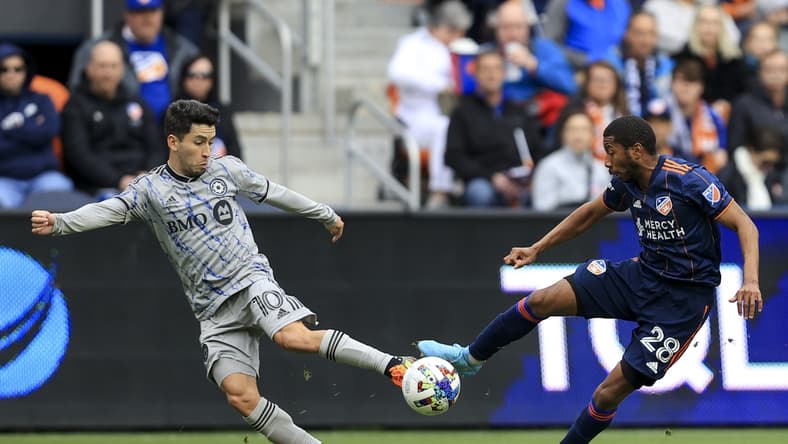 Apr 2, 2022; Cincinnati, Ohio, USA;  CF Montreal midfielder Joaquin Torres (10) plays the ball against FC Cincinnati defender Ray Gaddis (28) in the first half at TQL Stadium. Mandatory Credit: Aaron Doster-USA TODAY Sports