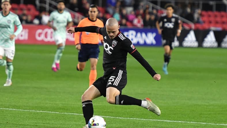 Apr 2, 2022; Washington, District of Columbia, USA; D.C. United defender Brad Smith (5) takes a shot in the first half against the Atlanta United at Audi Field. Mandatory Credit: Mitchell Layton-USA TODAY Sports