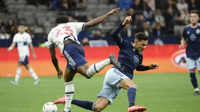Apr 2, 2022; Vancouver, British Columbia, CAN; Vancouver Whitecaps defender Javain Brown (23) and Sporting Kansas City forward Daniel Salloi (20) collide during the first half at BC Place. Mandatory Credit: Anne-Marie Sorvin-USA TODAY Sports