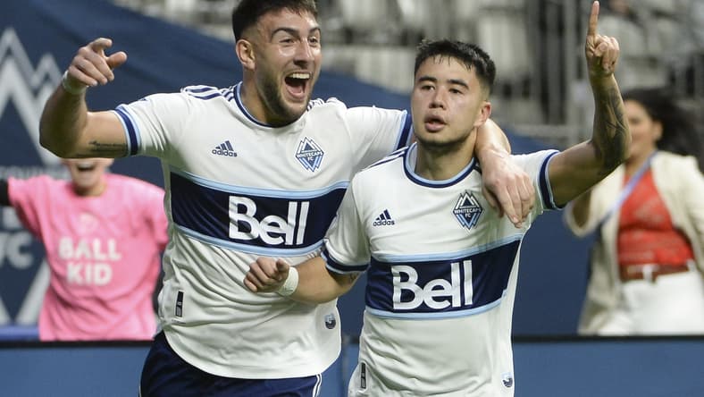 Apr 2, 2022; Vancouver, British Columbia, CAN; Vancouver Whitecaps midfielder Ryan Raposo (27) celebrates his goal against Sporting Kansas City goalkeeper Tim Melia (29) (not pictured) with forward Lucas Cavallini (9) during the second half at BC Place. Mandatory Credit: Anne-Marie Sorvin-USA TODAY Sports