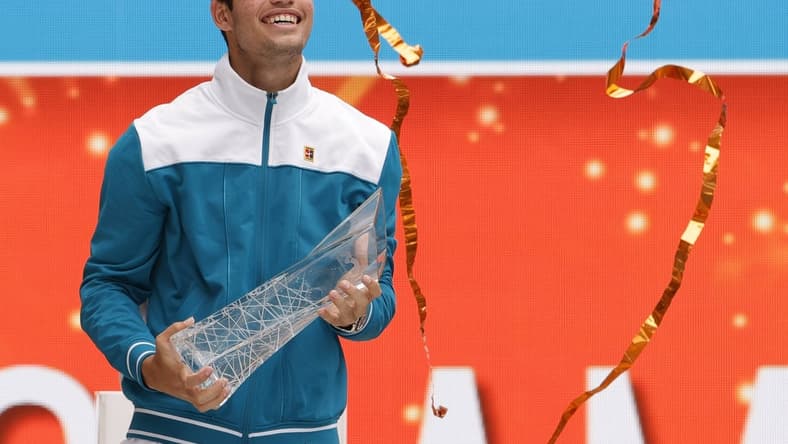 Apr 3, 2022; Miami Gardens, FL, USA; Carlos Alcaraz (ESP) celebrates with the Butch Buchholz Championship Trophy after his match against Casper Ruud (NOR)(not pictured) in the men's singles final in the Miami Open at Hard Rock Stadium. Mandatory Credit: Geoff Burke-USA TODAY Sports