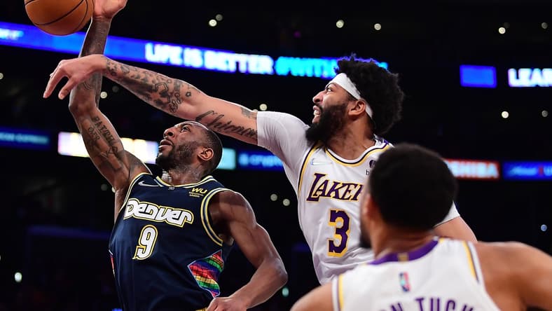 Apr 3, 2022; Los Angeles, California, USA; Los Angeles Lakers forward Anthony Davis (3) blocks the shot of Denver Nuggets guard Davon Reed (9) during the first half at Crypto.com Arena. Mandatory Credit: Gary A. Vasquez-USA TODAY Sports