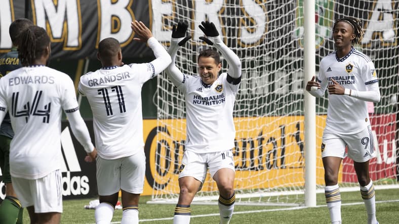 Apr 3, 2022; Portland, Oregon, USA; Los Angeles Galaxy forward Javier Hernandez (14) celebrates with midfielder Samuel Grandsir (11) after scoring a goal during the first half against the Portland Timbers at Providence Park. Mandatory Credit: Troy Wayrynen-USA TODAY Sports