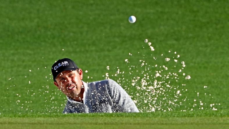 Apr 8, 2022; Augusta, Georgia, USA; Charl Schwartzel plays a shot from a bunker on the second hole during the second round of The Masters golf tournament. Mandatory Credit: Kyle Terada-USA TODAY Sports
