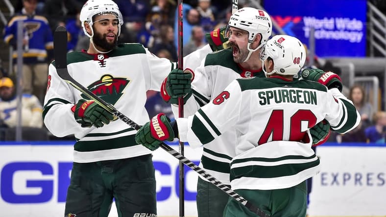 Apr 8, 2022; St. Louis, Missouri, USA;  Minnesota Wild defenseman Jacob Middleton (5) celebrates with defenseman Jared Spurgeon (46) and left wing Jordan Greenway (18) after scoring against the St. Louis Blues during the third period at Enterprise Center. Mandatory Credit: Jeff Curry-USA TODAY Sports