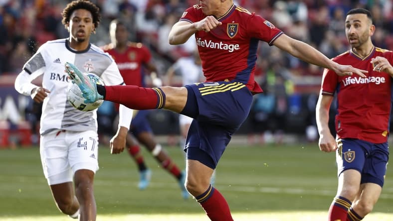 Apr 9, 2022; Sandy, Utah, USA; Real Salt Lake forward Tate Schmitt (21) shoots against Toronto FC midfielder Kosi Thompson (47) in the first half at Rio Tinto Stadium. Mandatory Credit: Jeffrey Swinger-USA TODAY Sports