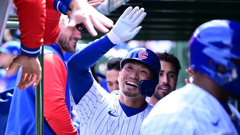 Apr 10, 2022; Chicago, Illinois, USA; Chicago Cubs right fielder Seiya Suzuki (27) celebrates in the dugout with teammates after his three run home run in the first inning against the Milwaukee Brewers at Wrigley Field. Mandatory Credit: Quinn Harris-USA TODAY Sports