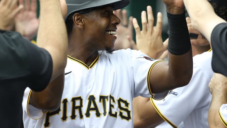 Apr 13, 2022; Pittsburgh, Pennsylvania, USA;  Pittsburgh Pirates third baseman Ke'Bryan Hayes (13) high-fives in the dugout after scoring a run against the Chicago Cubs during the third inning at PNC Park. Mandatory Credit: Charles LeClaire-USA TODAY Sports