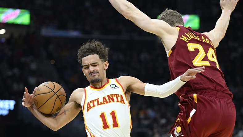 Apr 15, 2022; Cleveland, Ohio, USA; Cleveland Cavaliers forward Lauri Markkanen (24) defends Atlanta Hawks guard Trae Young (11) in the second quarter at Rocket Mortgage FieldHouse. Mandatory Credit: David Richard-USA TODAY Sports